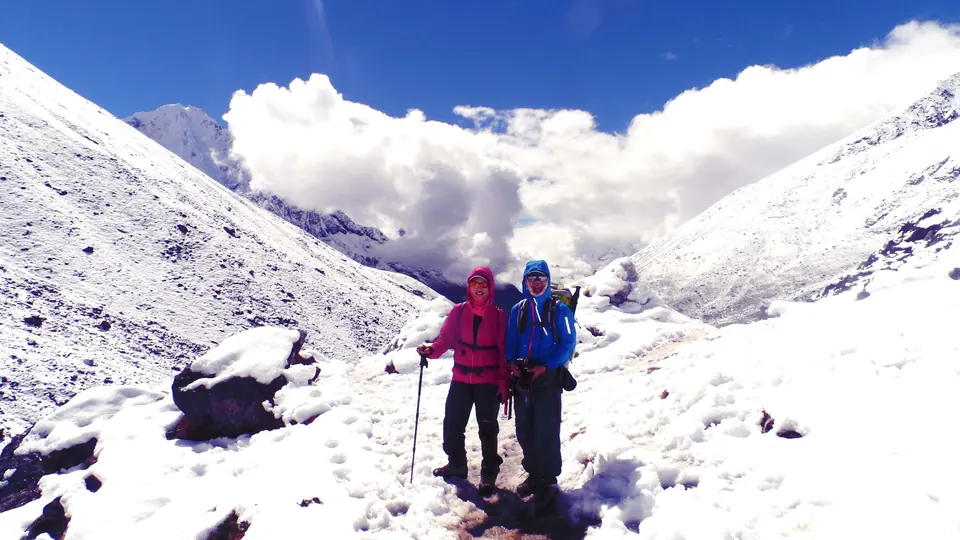 Trekkers on a snowy trail in the Gokyo valley
