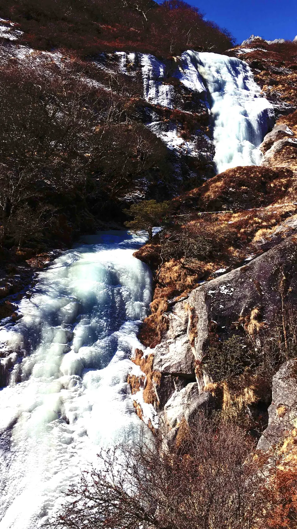 Frozen waterfall beside the trail in the Everest region