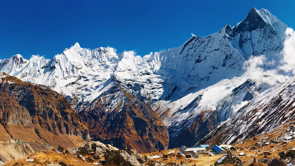 Machhapuchhre and the Annapurna range above forested ridges