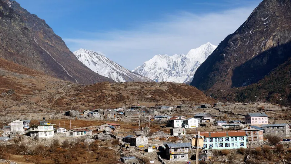 Village in the upper Langtang valley below snow peaks