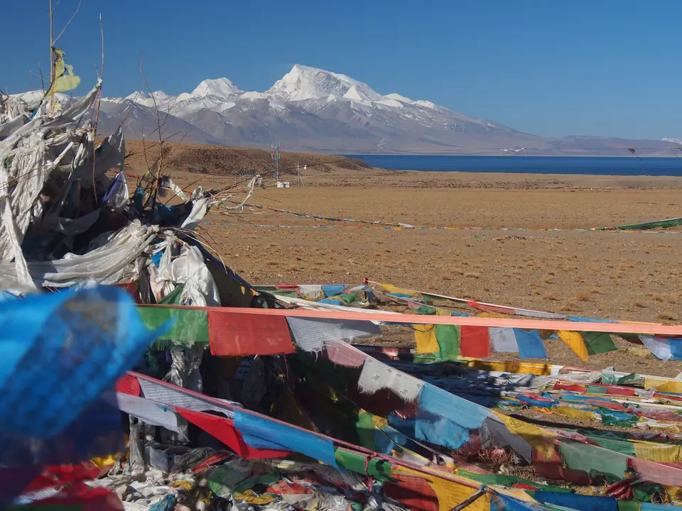 Lake Manasarovar with prayer flags and Gurla Mandhata behind