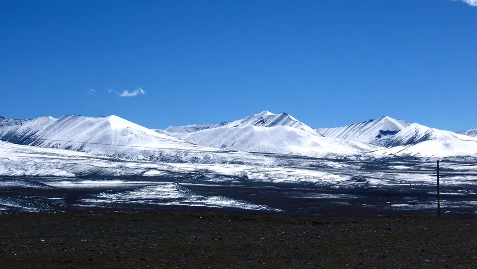 Snow-dusted ridges under a clear sky in Bhutan